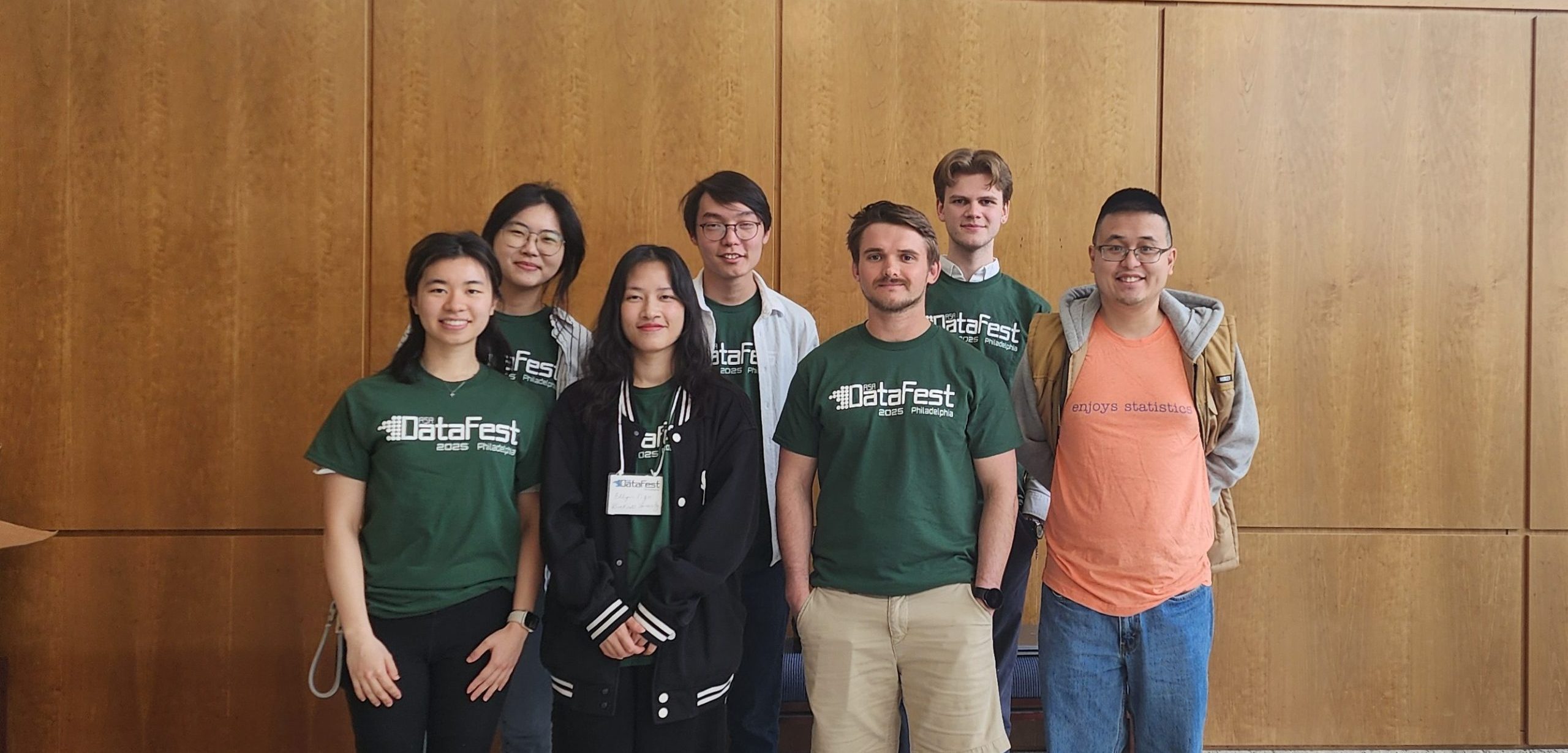 A group photo of students from DataFest2025, all wearing tshirts with the name of the event on them. Standing with them is Keegan Kang, their faculty advisor.