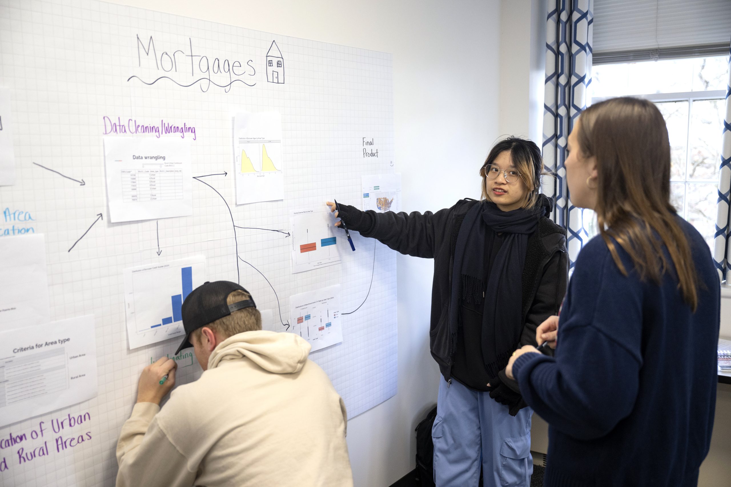 A group of students from Bucknell walking into a building on the Villanova campus in the spring.